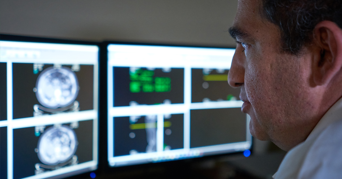 A physician reviewing results on a computer screen for testicular cancer
