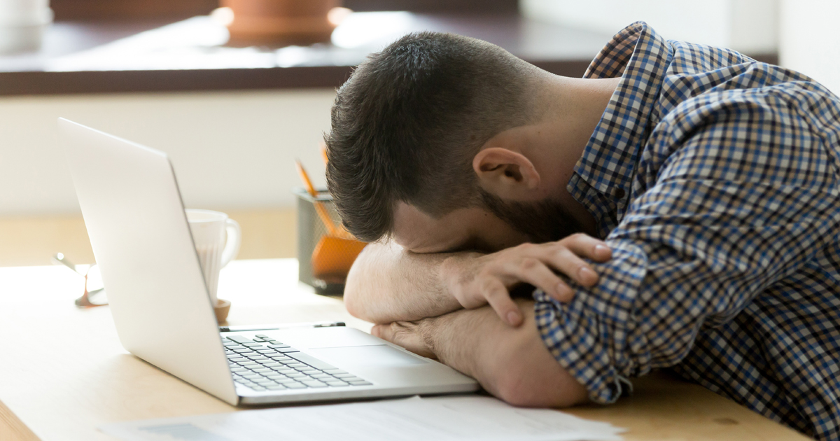A male cancer patient experiencing fatigue while working