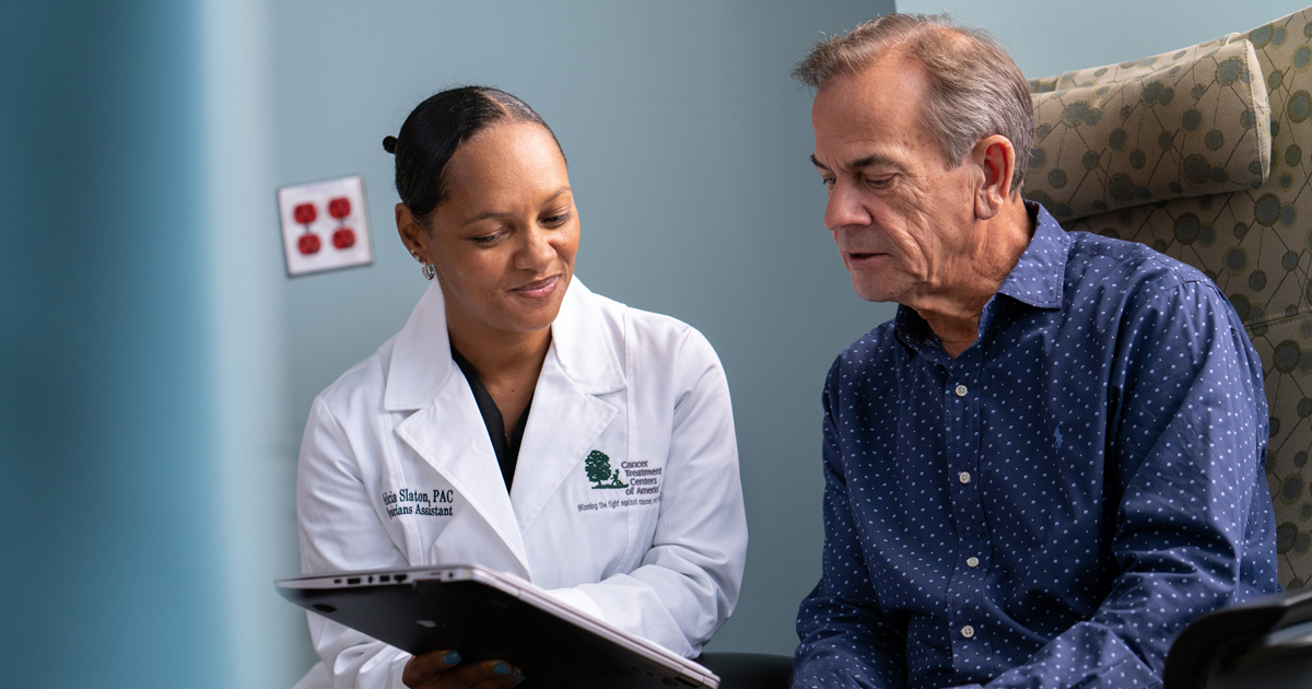 A female cancer treatment centers of america physician discussing cancer treatment with a male patient